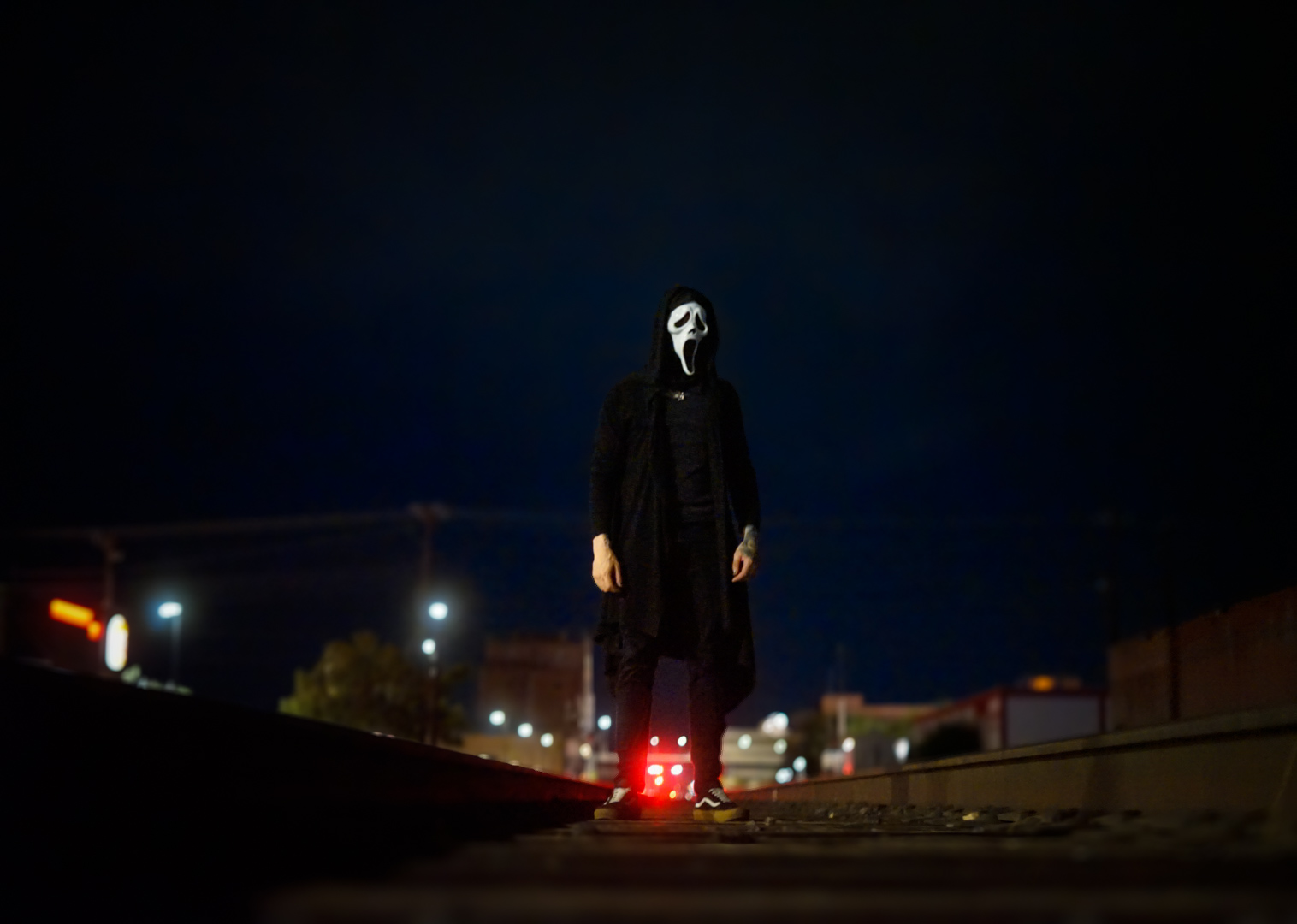 Ghostface mask on night train tracks from The Eclipse session