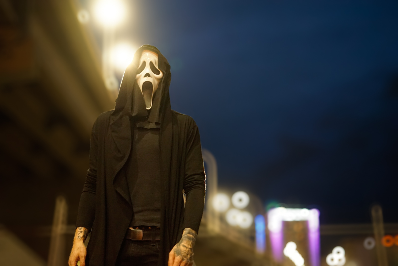 Person in a Ghostface mask under streetlights from The Shadow session
